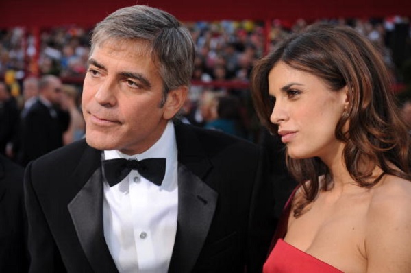Actor George Clooney listens to a report